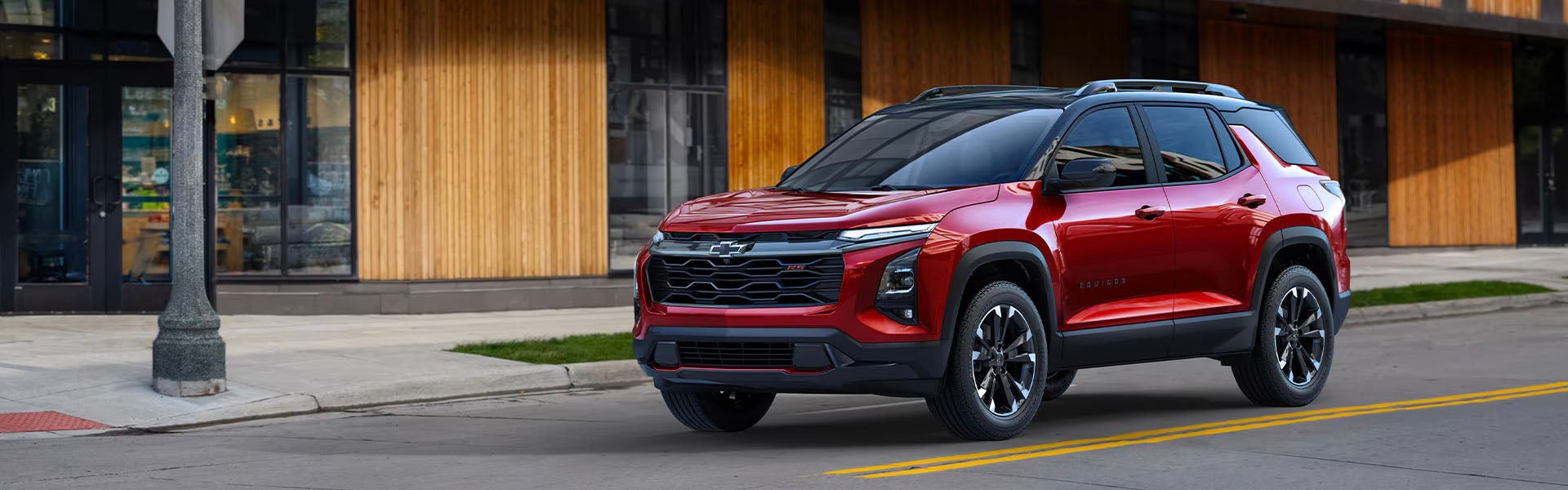 A red 2025 Chevrolet Equinox on road